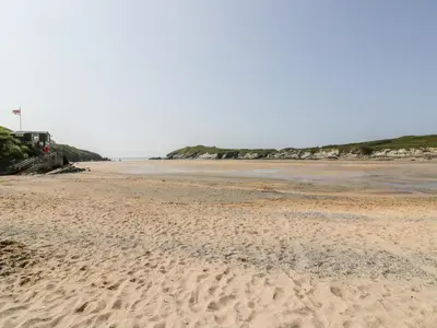 a sandy beach with footprints in the sand at Flat 2 in Newquay