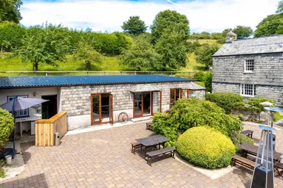 an aerial view of a stone building with a patio at Ta Mill Cottages & Lodges - Smithy Cottage in Launceston