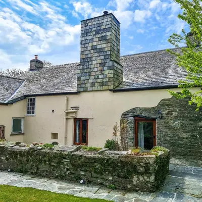 a stone house with a chimney on top of it at Ta Mill Cottages & Lodges - Pump Cottage in Launceston