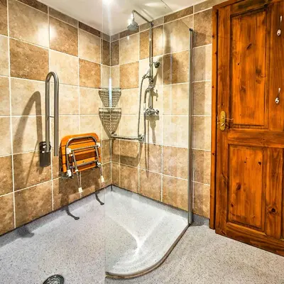 a bathroom with a shower with a tub and a glass door at Ta Mill Cottages & Lodges - Dairy Cottage in Launceston