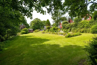 a large yard with green grass and trees at Ta Mill Cottages & Lodges - Dairy Cottage in Launceston