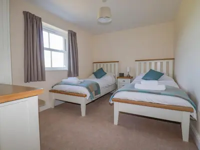 a bedroom with two beds and a window at Ilgram in Newquay