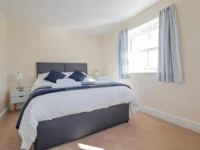 a bedroom with a large bed and a window at Ilgram in Newquay