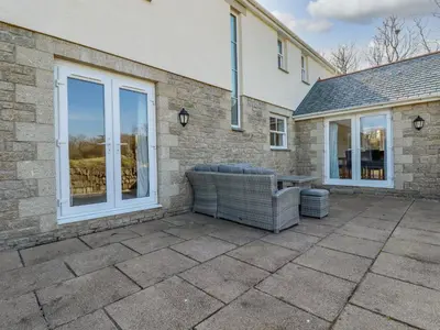 a patio with a couch and a table at Ilgram in Newquay