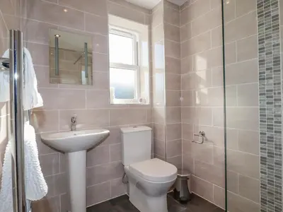 a bathroom with a toilet and a sink at Ilgram in Newquay