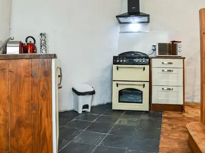 a kitchen with a stove and a sink at The Old Barn in Saint Day