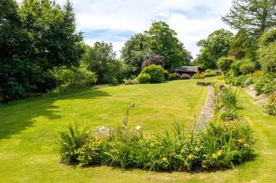 a garden with green grass and flowers at Ta Mill Cottages & Lodges - Meadowview Chalet 1 in Launceston