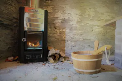 a kitchen with a fireplace and a pot with a banana at Ta Mill Cottages & Lodges - Meadowview Chalet 2 in Launceston