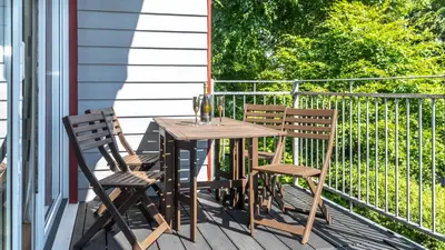 a wooden table and two chairs on a porch at Ta Mill Cottages & Lodges - Meadowview Chalet 4 in Launceston