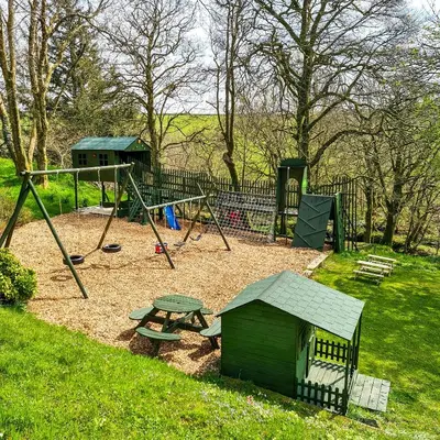 a playground with a picnic table and a swing at Ta Mill Cottages & Lodges - Brookview Lodge 1 in Launceston