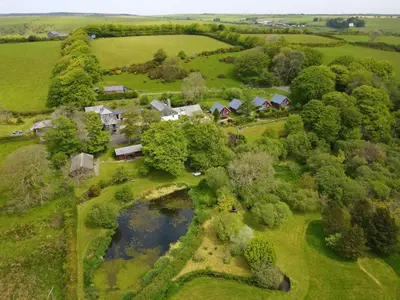 an aerial view of a farm with a pond at Ta Mill Cottages & Lodges - Brookview Lodge 3 in Launceston