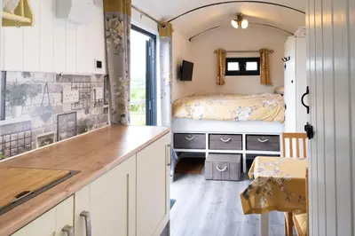 a kitchen with a sink and a bed in a room at Shepherds hut with valley views in Bodmin