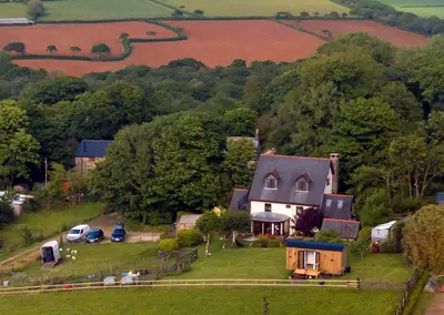 an aerial view of a house on a hill at Shepherds hut with valley views in Bodmin