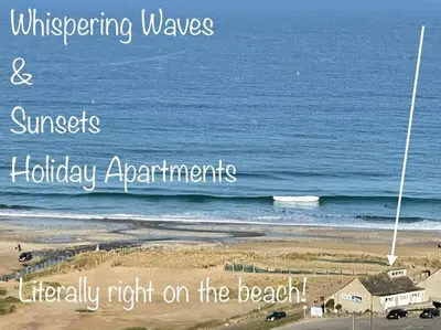 a picture of the beach with the wordswrecking waves and sunsetholiday appliances therapy at Whispering Waves in Porthtowan, Beachfront Apartment in Porthtowan