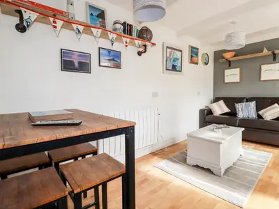 a living room with a table and a couch at The Moonbeach Cabin in Gorran Haven