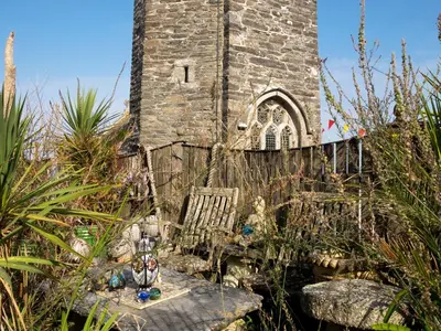 an old church in the middle of a garden at The Moonbeach Cabin in Gorran Haven