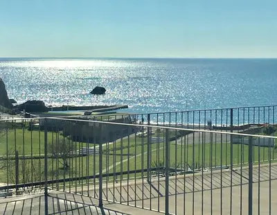a view of the ocean from a balcony at Bay View, Millendreth Looe Cornwall in Looe