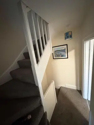 a staircase in a home with a stair case at Seagull Cottage in Looe