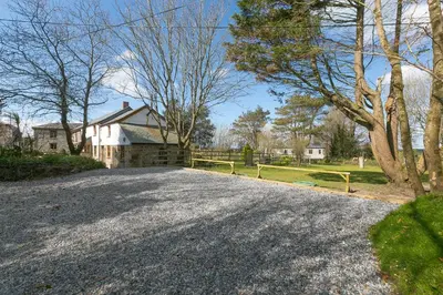 a driveway in front of a house with a fence at The Annex - Trewolla Cottage in Newquay
