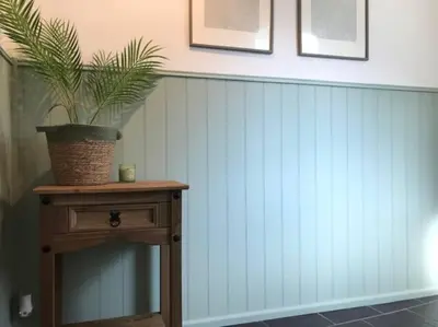 a potted plant on top of a wooden table at Woodland cottage in Cornwall with walled garden in Helston