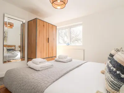 a bedroom with a large bed with towels on it at Amal Anpras in Tintagel