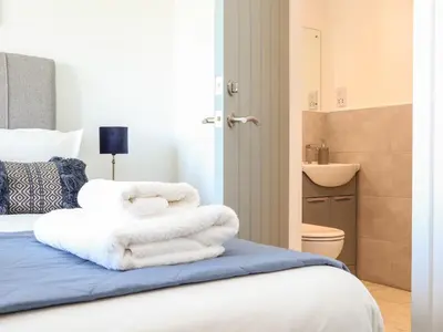 a pile of towels sitting on top of a bed at Amal Anpras in Tintagel