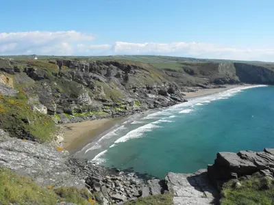 an aerial view of a beach on a cliff at Amal Anpras in Tintagel