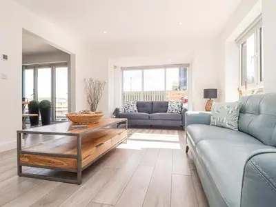 a living room with a couch and a table at Amal Anpras in Tintagel