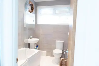 a bathroom with a white toilet and a sink at Hoblyns Cove in Holywell Bay