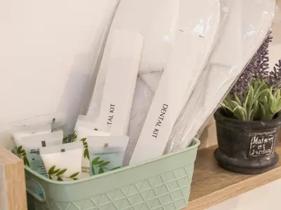 a green basket sitting on a shelf with plants at Lighthouse Lofts - Godrevy in Camborne