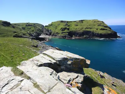 an island in the ocean next to a body of water at Badgers Rest in Tintagel