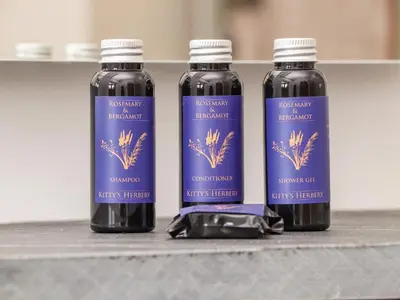 three bottles of liquid sitting on a counter at Rosewarrick Cottage in Bodmin