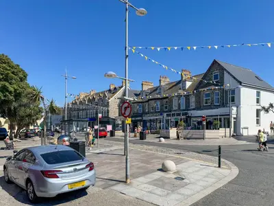 a car parked in front of a street with buildings at Summer Breeze in Newquay