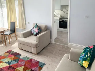 a living room with a couch and a chair at Summer Breeze in Newquay