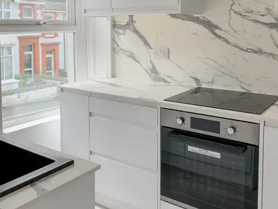 a kitchen with a stove and a counter top at Summer Breeze in Newquay