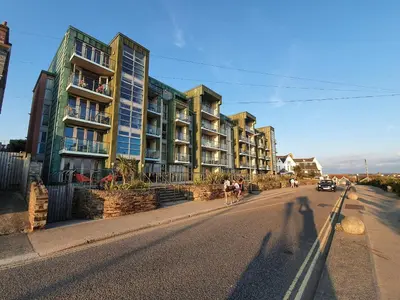 a shadow of a person riding a bike down a street at Apartment 4, Zinc in Newquay
