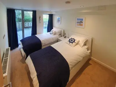 a hotel room with two beds and a window at Apartment 4, Zinc in Newquay