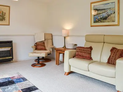a living room with a couch and a chair at Heather Cottage in Saint Erth