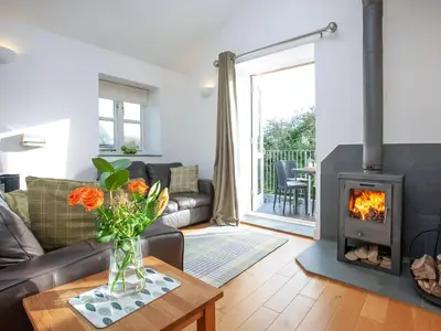 a living room with a couch and a fireplace at Old Dairy - Uk36514 in Germoe