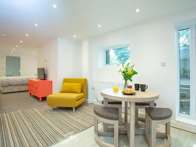 a living room with a table and a yellow chair at Crofty's Celder - Uk35181 in Pool