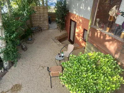 a patio with two chairs and a table and a bush at Crofty's Celder - Uk35181 in Pool