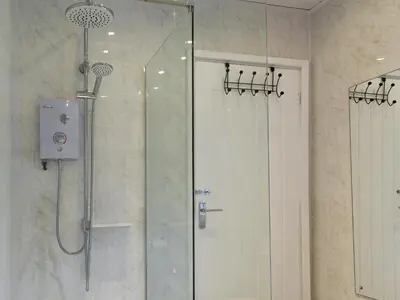 a shower with a glass door in a bathroom at The Lily Pad in St Merryn