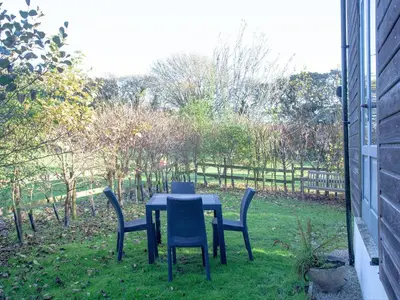 a table and chairs sitting in the grass at The Hayloft - Uk36516 in Germoe