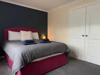 a bedroom with a bed with two blue towels on it at Apartment 11 Chester Road Newquay in Newquay