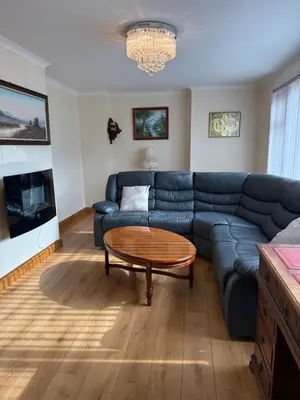 a living room with a blue couch and a coffee table at Apartment 11 Chester Road Newquay in Newquay
