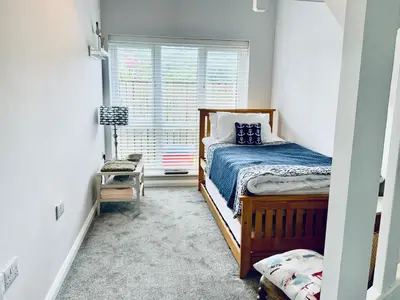 a bedroom with a bed and a window at 1 Bed Cottage - Sleeps 2 - Parking - Wifi in Truro