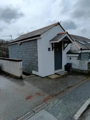 a small white building with a door on a street at 1 Bed Cottage - Sleeps 2 - Parking - Wifi in Truro