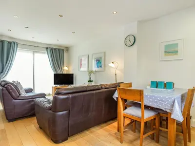 a living room with a couch and a table at Constantine Bay Cottage in Padstow