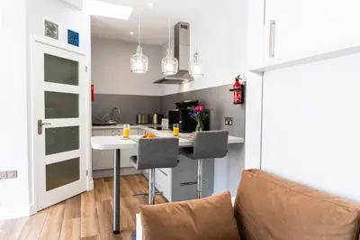 a kitchen with a table and chairs in a room at Finest Retreats - The Hideaway - Studio Apartment in Porthleven in Porthleven