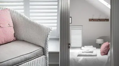 a bedroom with a chair and a table with a lamp at St Tudy Inn in Bodmin